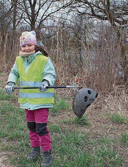 Dieses Mädchen präsentiert einen skurrilen Fund.